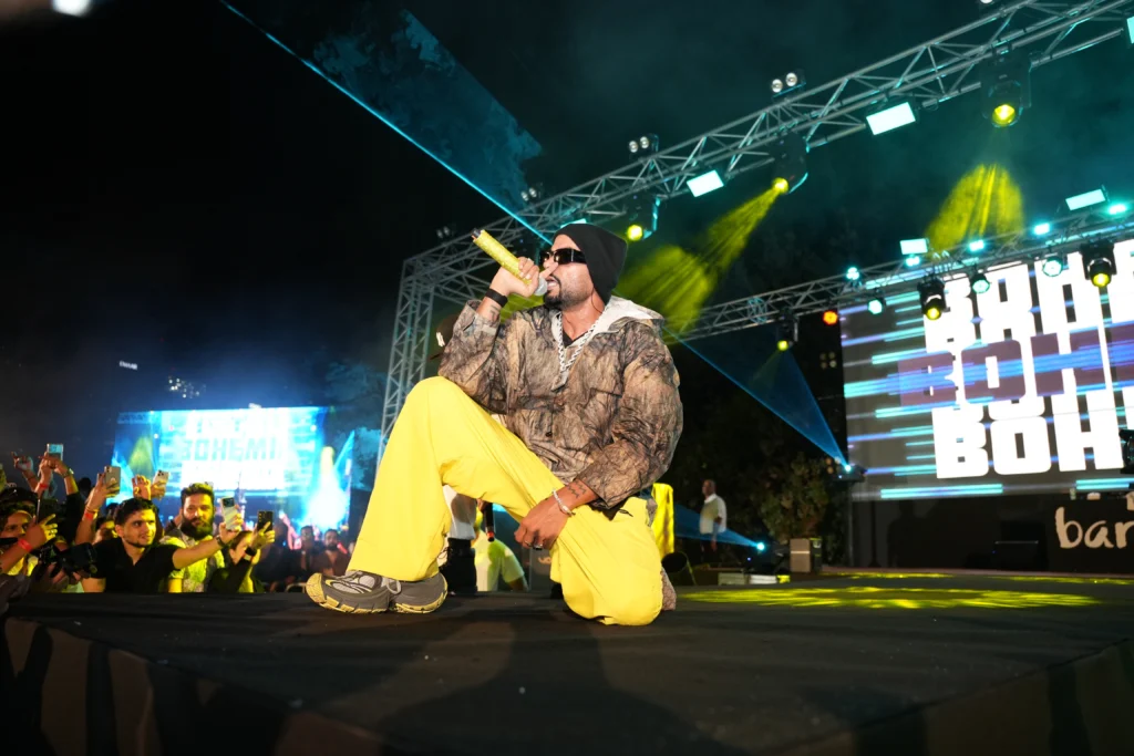 Bohemia the Punjabi Rapper performing live at Barasti Beach Dubai with an energetic crowd, branded LED screens and dynamic yellow and blue stage lighting